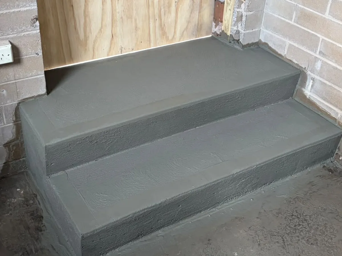 Two freshly poured concrete steps at a commercial entry