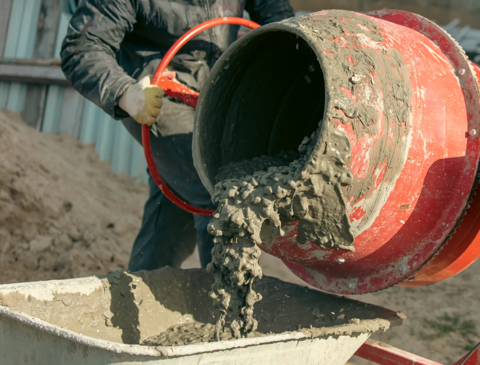 Concrete mixer discharging into a barrow