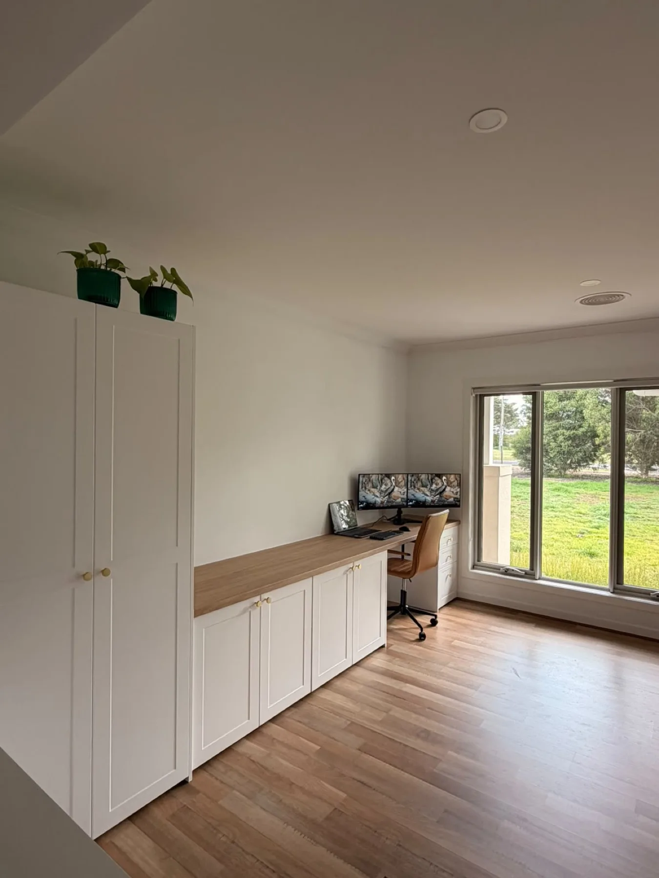 Finished cabinetry, wider angle with the window