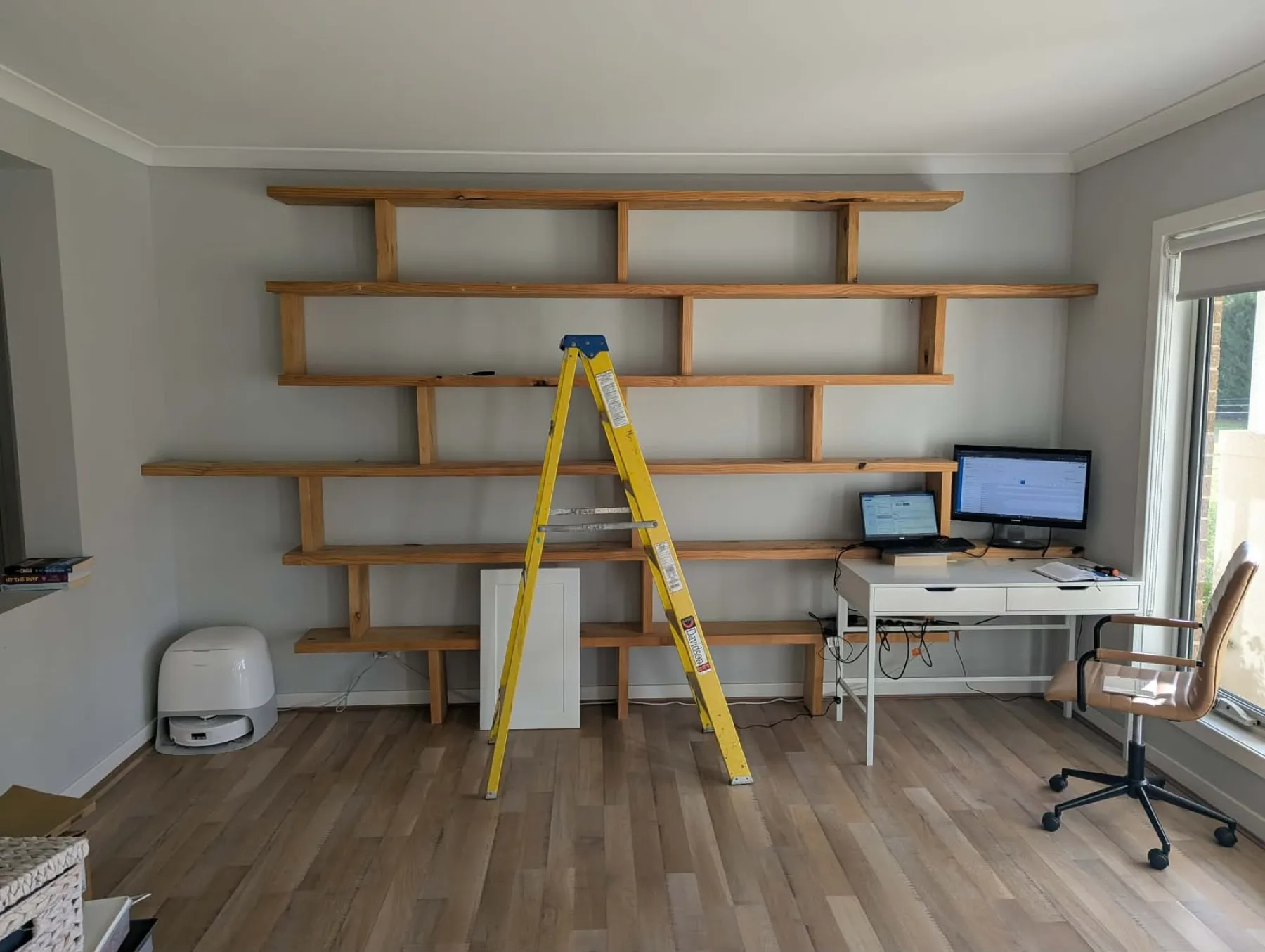 Same wall stripped with a ladder up before the cabinetry install