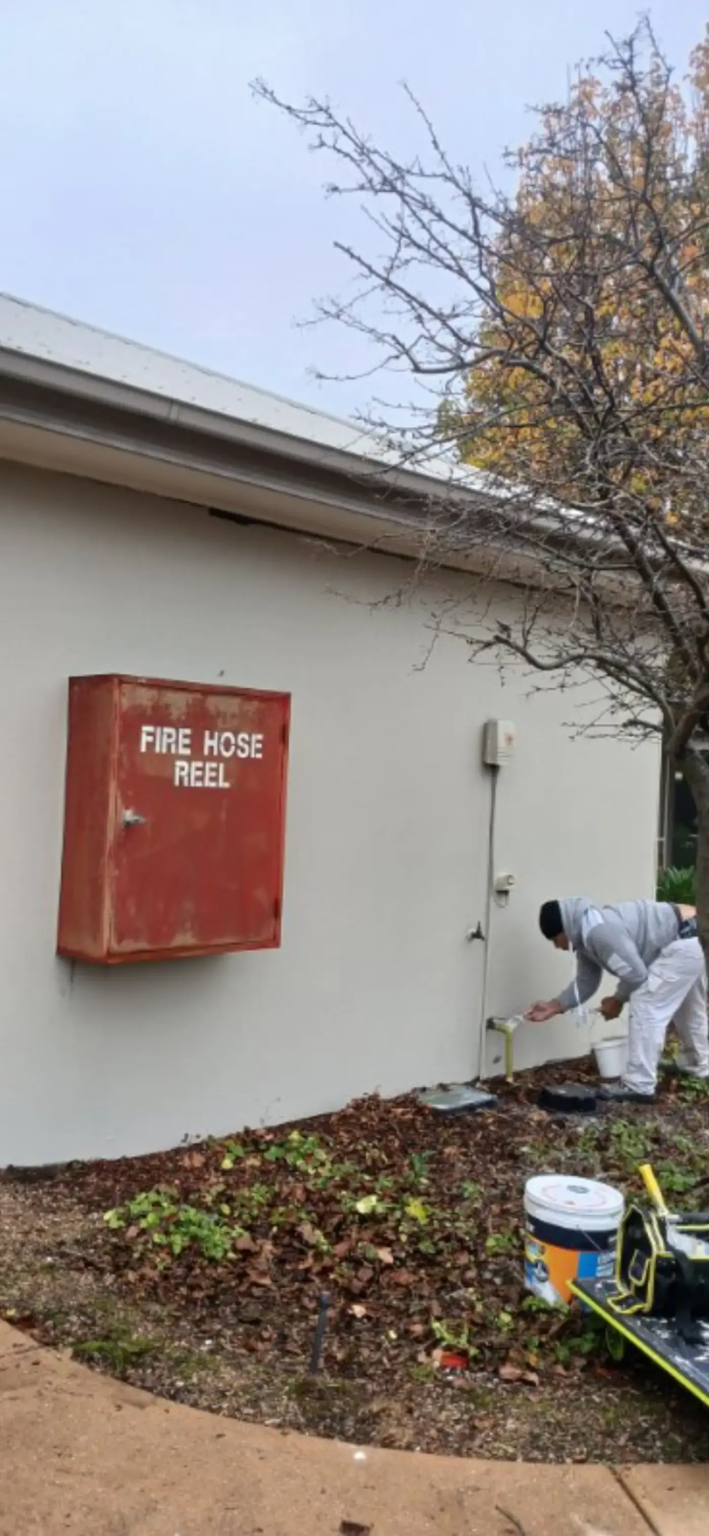 Painter working on an external commercial facade